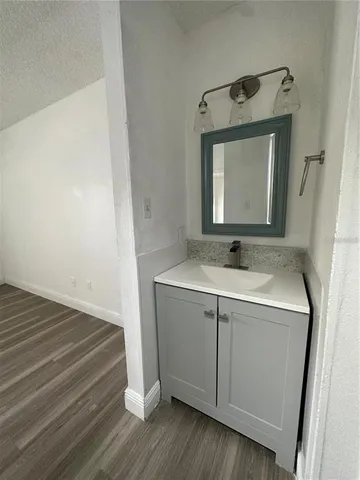 a bathroom with a sink vanity and mirror