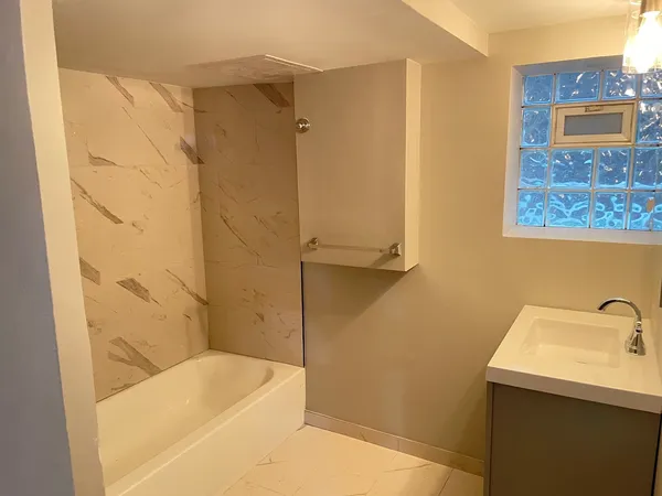 a bathroom with a bathtub and shower