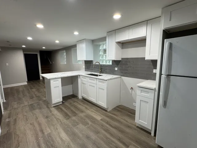 a kitchen with a sink stainless steel appliances and cabinets