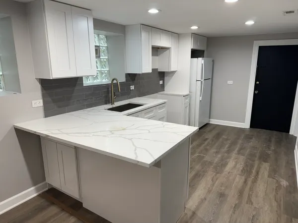 a kitchen with stainless steel appliances a refrigerator sink and microwave