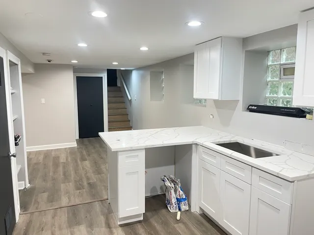 a kitchen with a sink cabinets and window