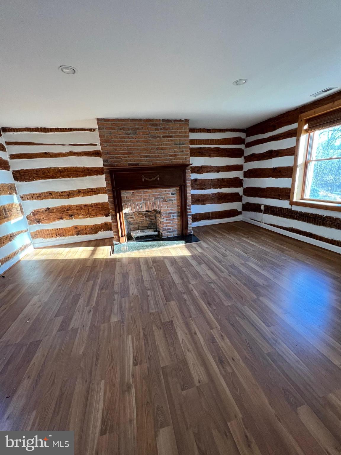 2834 East Boss Arnold Road Jefferson, MD 21755 - Photo 11 of 16 a view of empty room with wooden floor and fan