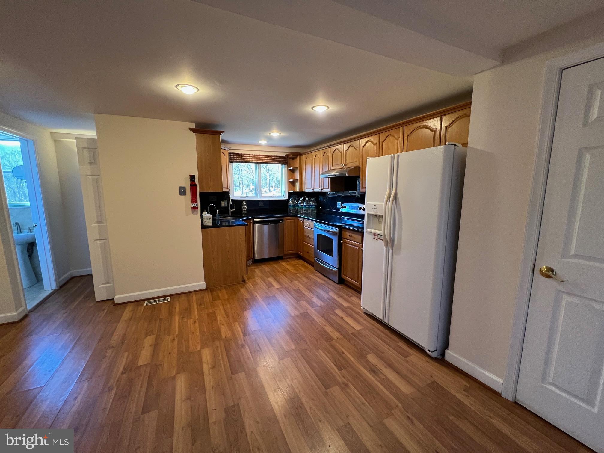 2834 East Boss Arnold Road Jefferson, MD 21755 - Photo 3 of 16 a kitchen with a refrigerator a sink and wooden floor