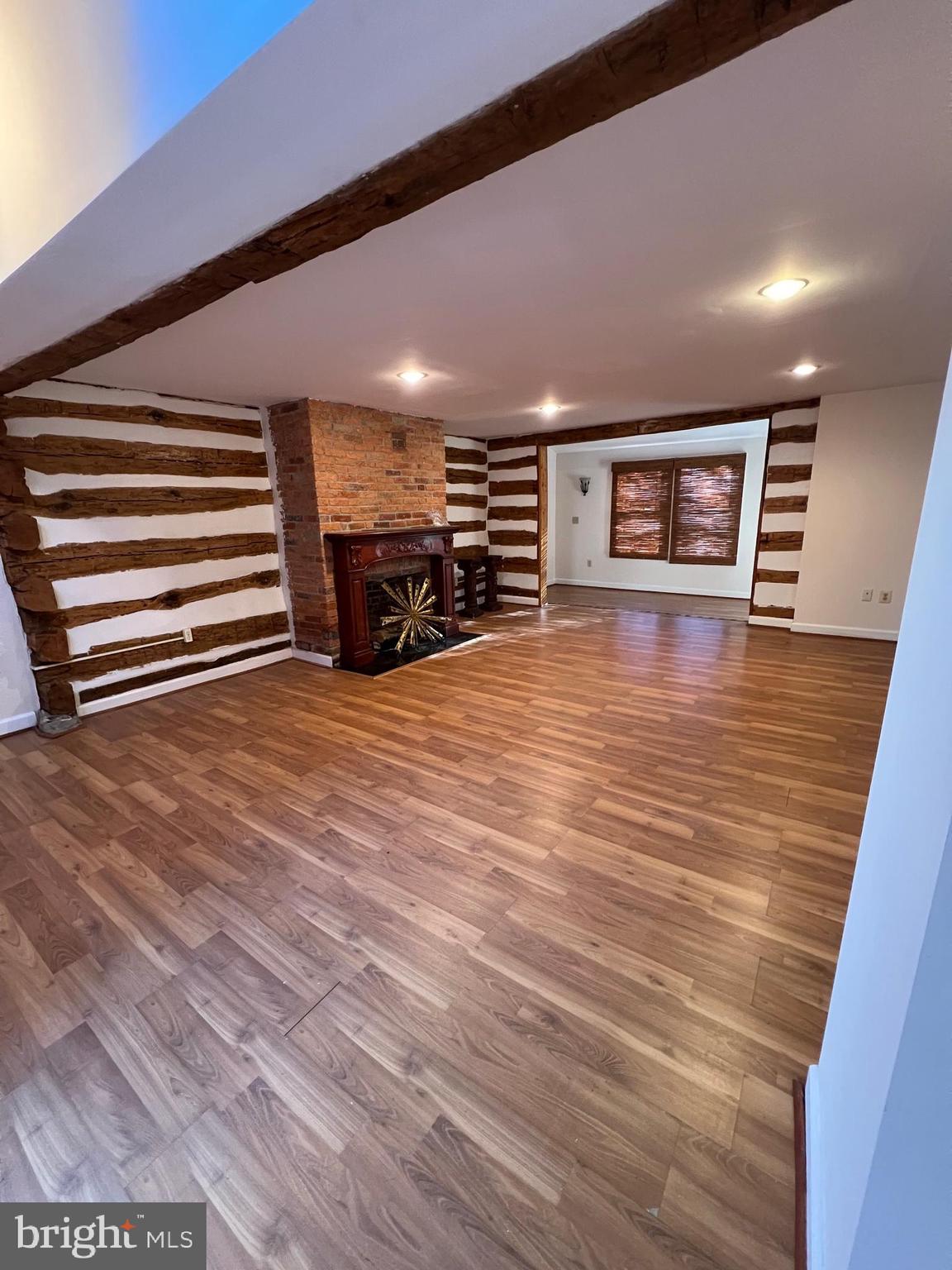 2834 East Boss Arnold Road Jefferson, MD 21755 - Photo 4 of 16 a view of an empty room with wooden floor and a ceiling fan