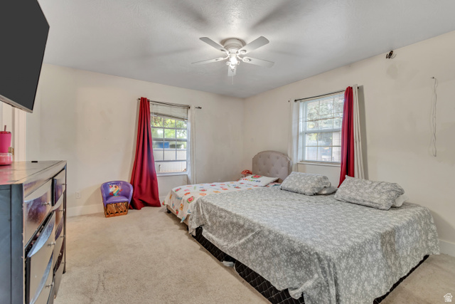 1225 North 1380th Street West Mapleton, UT 84664 - Photo 9 of 17 Carpeted bedroom with two windows featuring red drapes