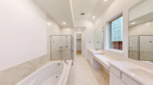 a bathroom with a bathtub shower sink and mirror