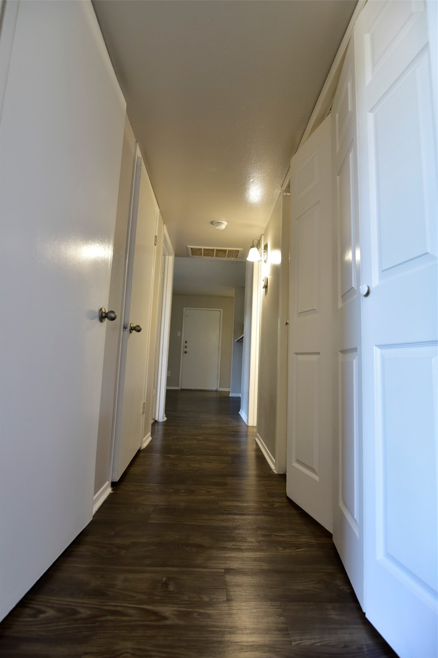 14403 Pavilion Point, Unit 488 Houston, TX 77083 - Photo 9 of 15 a view of a hallway with wooden floor