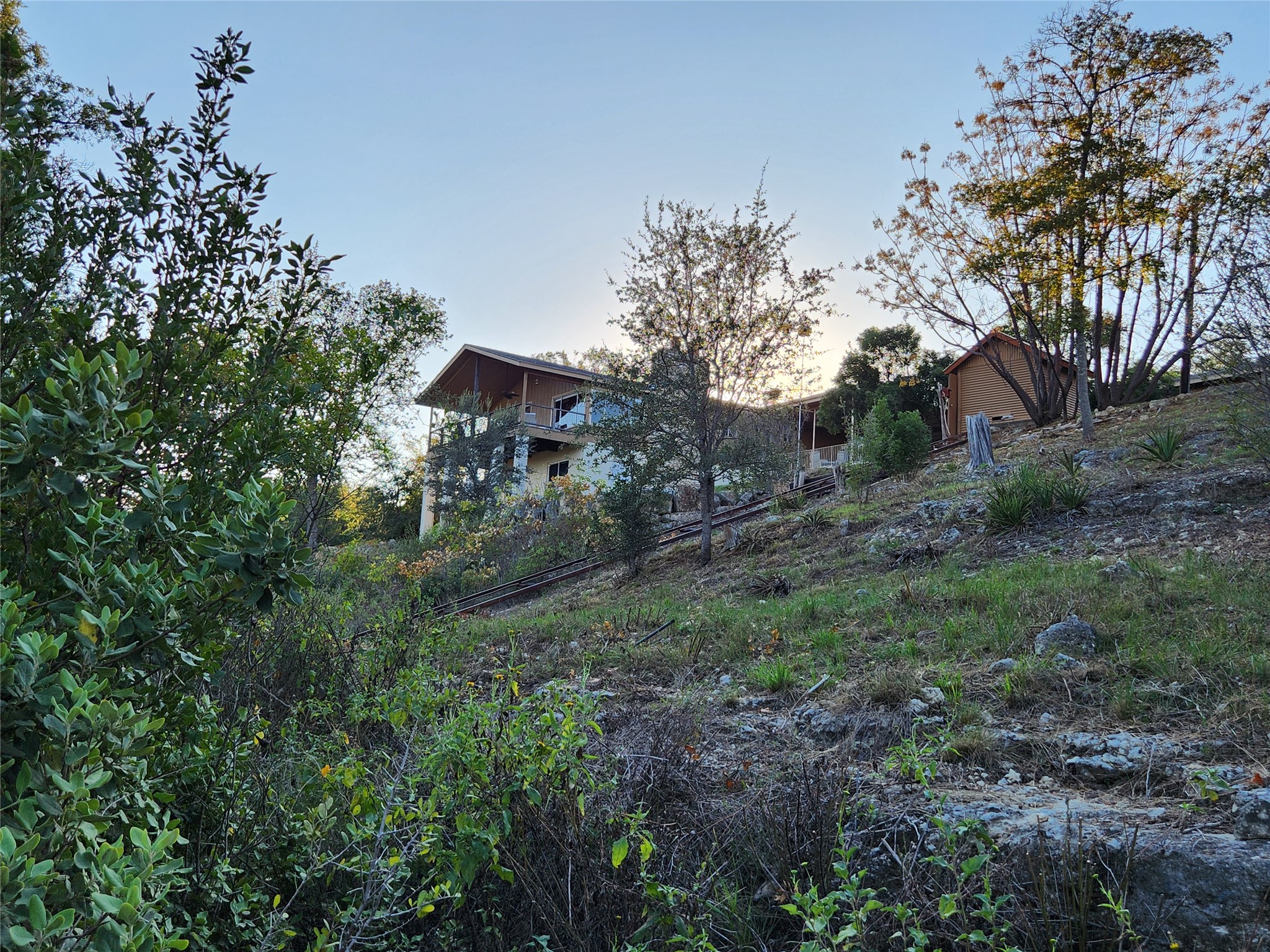 3807 Boat Dock Road Lago Vista, TX 78645 - Photo 33 of 37 Hillside home nestled among natural landscaping provides a private retreat.