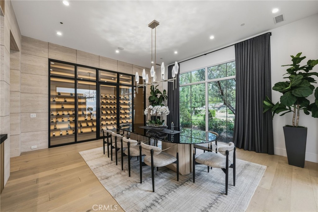 5241 Twin Oaks Road Hidden Hills, CA 91302 - Photo 11 of 69 a dining room with furniture and a floor to ceiling window