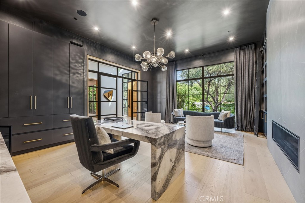 5241 Twin Oaks Road Hidden Hills, CA 91302 - Photo 18 of 69 a view of a dining room with furniture a chandelier and wooden floor