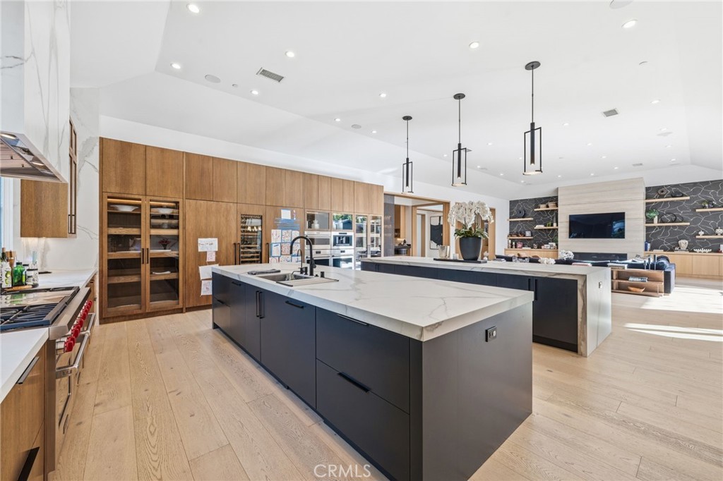 5241 Twin Oaks Road Hidden Hills, CA 91302 - Photo 28 of 69 a kitchen with stainless steel appliances kitchen island granite countertop a sink and cabinets