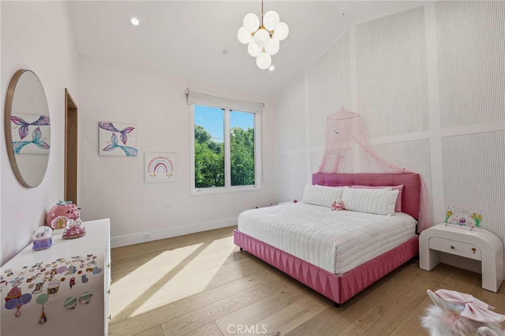 5241 Twin Oaks Road Hidden Hills, CA 91302 - Photo 50 of 69 a bedroom with a bed and a chandelier