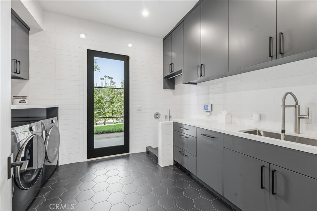 5241 Twin Oaks Road Hidden Hills, CA 91302 - Photo 52 of 69 a view of a kitchen with sink washer and dryer