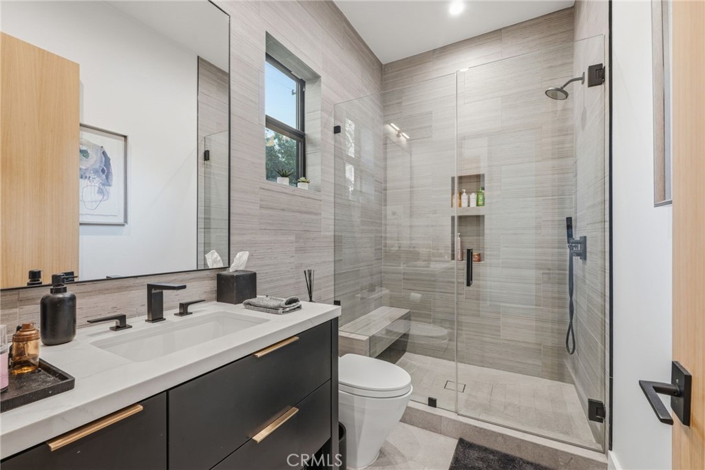5241 Twin Oaks Road Hidden Hills, CA 91302 - Photo 61 of 69 a bathroom with a granite countertop sink toilet and shower