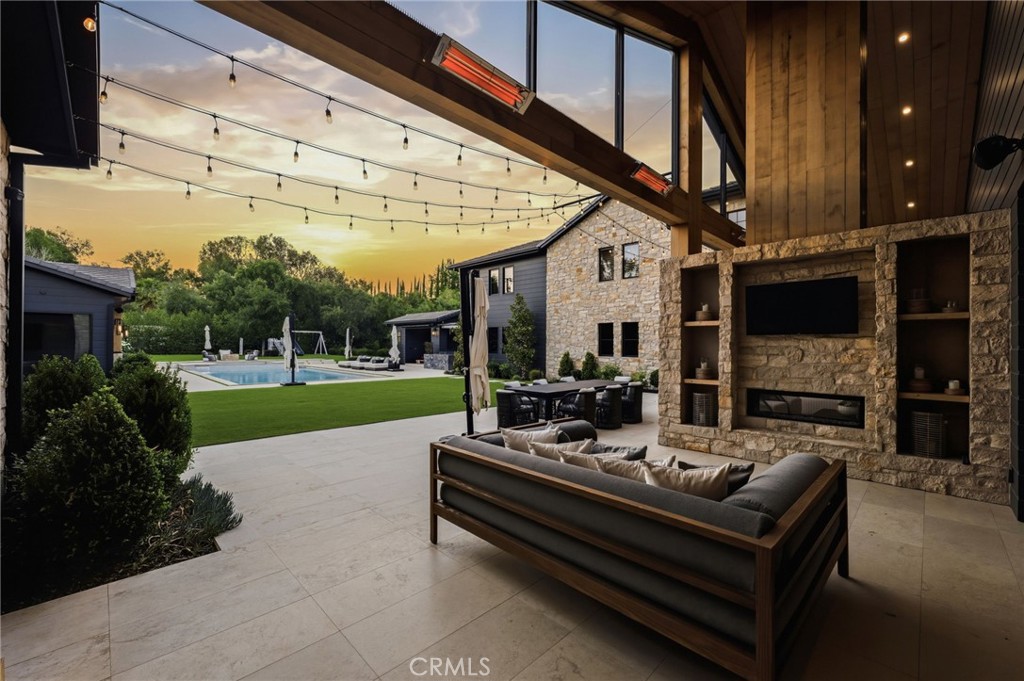 5241 Twin Oaks Road Hidden Hills, CA 91302 - Photo 65 of 69 a view of a patio with couches table and chairs with garden view