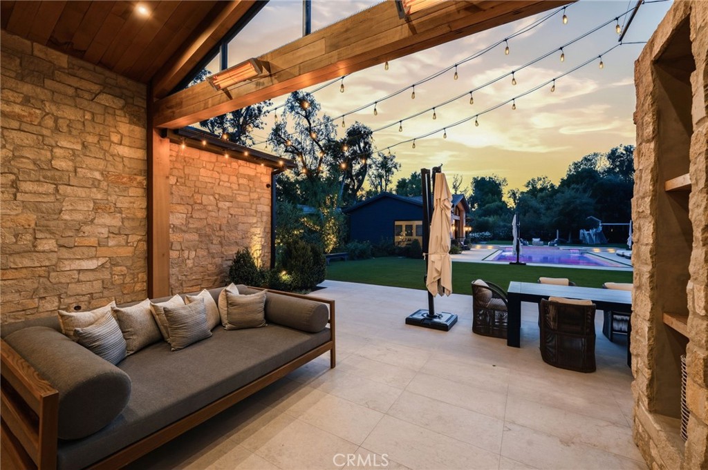 5241 Twin Oaks Road Hidden Hills, CA 91302 - Photo 7 of 69 a view of a patio with a couch and a fire pit