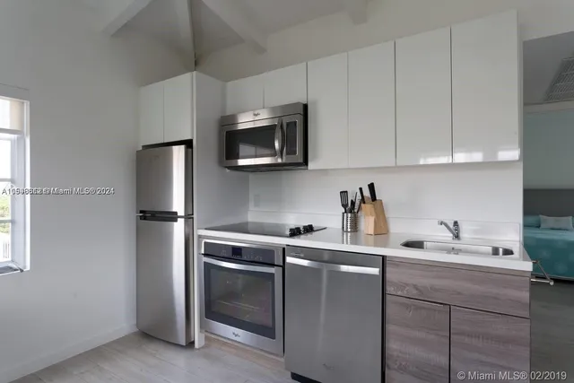 a kitchen with a sink cabinets and stainless steel appliances