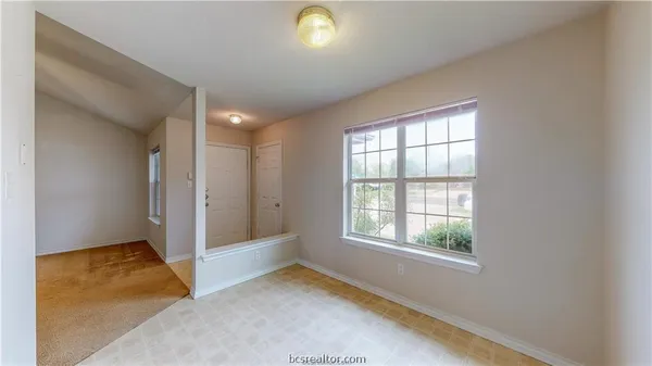 an empty room with windows and closet
