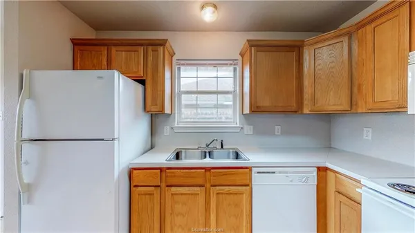 a white refrigerator freezer sitting in a kitchen