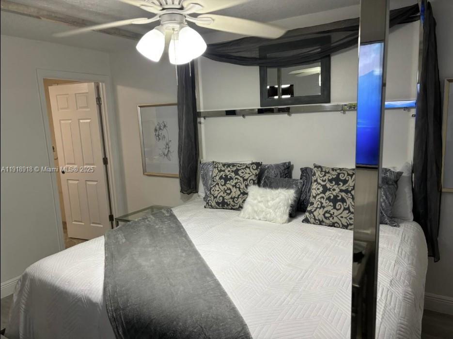 St. Lucie Estates-Broadway Stuart, FL 34996 - Photo 2 of 12 a bed room with a bed and a mirror