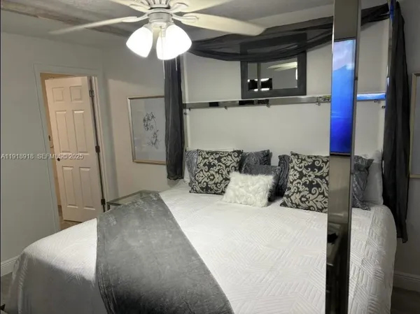 a bed room with a bed and a mirror