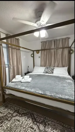 a bed sitting in a bedroom next to a window