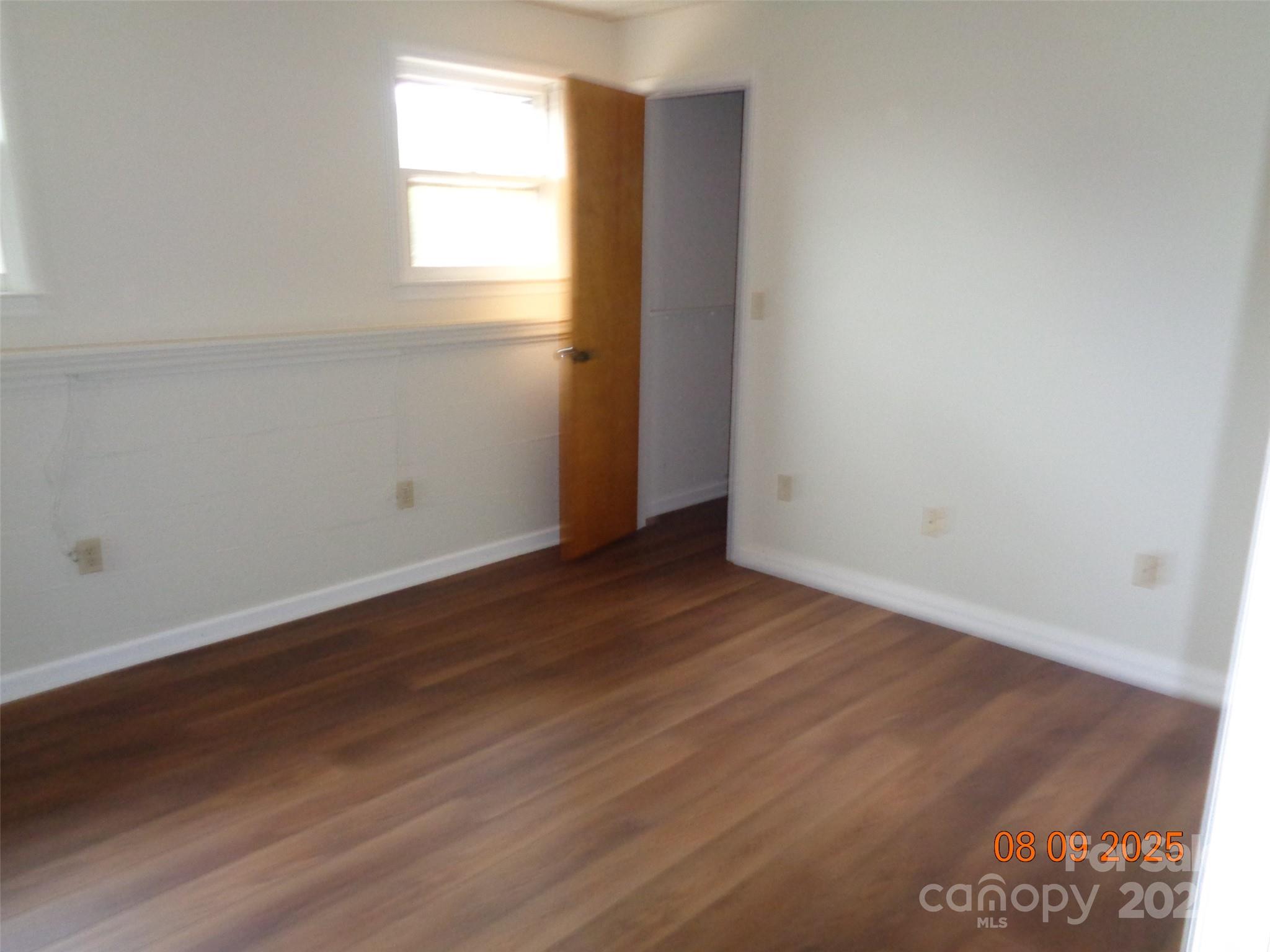 1203 Dudley Shoals Road Granite Falls, NC 28630 - Photo 16 of 32 an empty room with wooden floor and windows