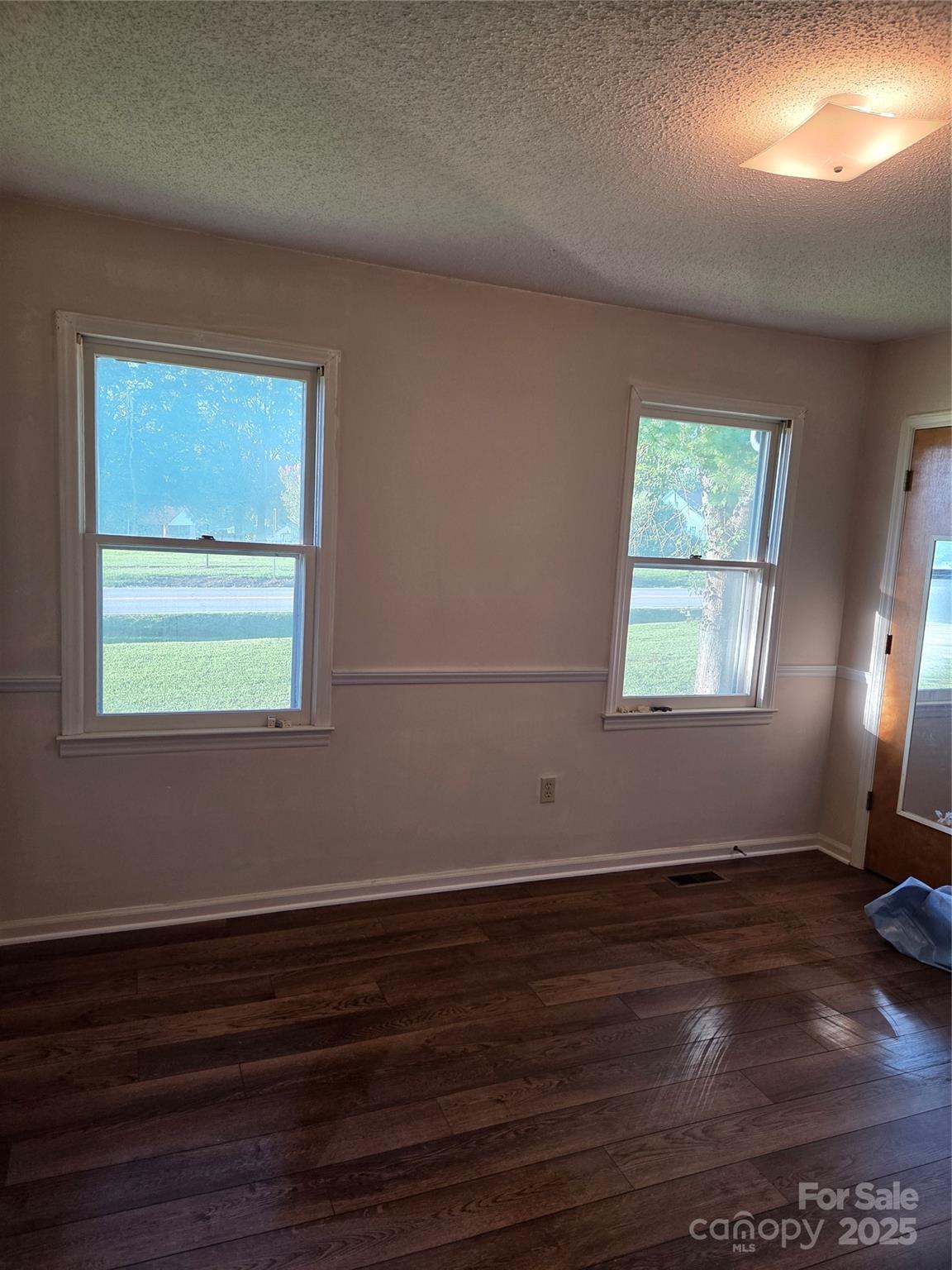 1203 Dudley Shoals Road Granite Falls, NC 28630 - Photo 17 of 32 an empty room with wooden floor and windows