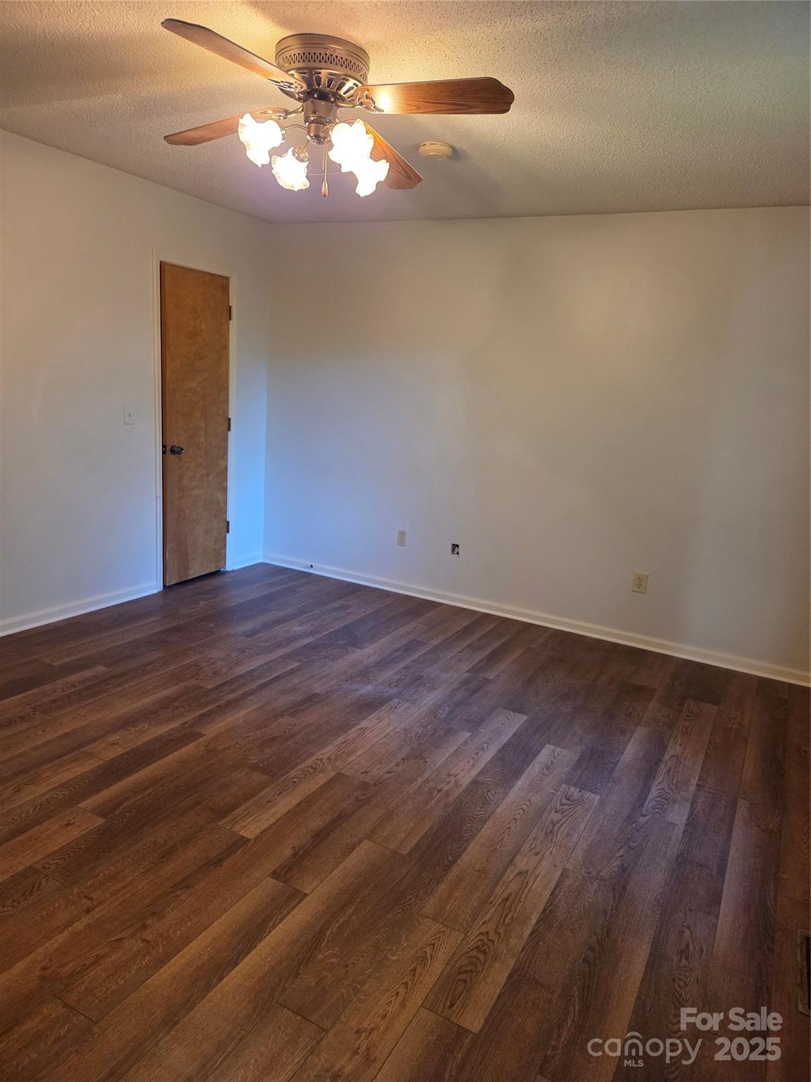 1203 Dudley Shoals Road Granite Falls, NC 28630 - Photo 18 of 32 a view of a room with wooden floor and chandelier fan