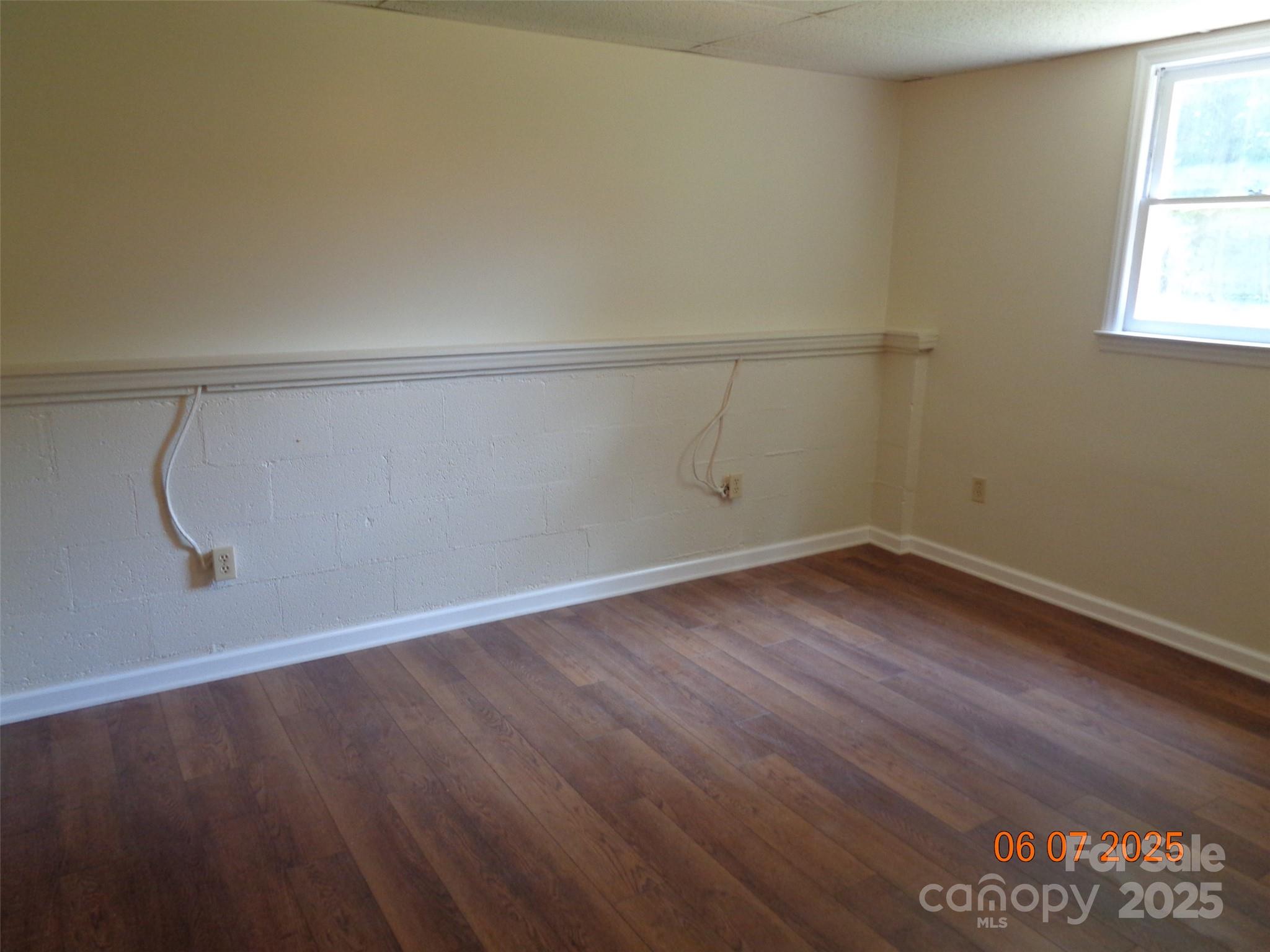 1203 Dudley Shoals Road Granite Falls, NC 28630 - Photo 30 of 32 an empty room with wooden floor and windows