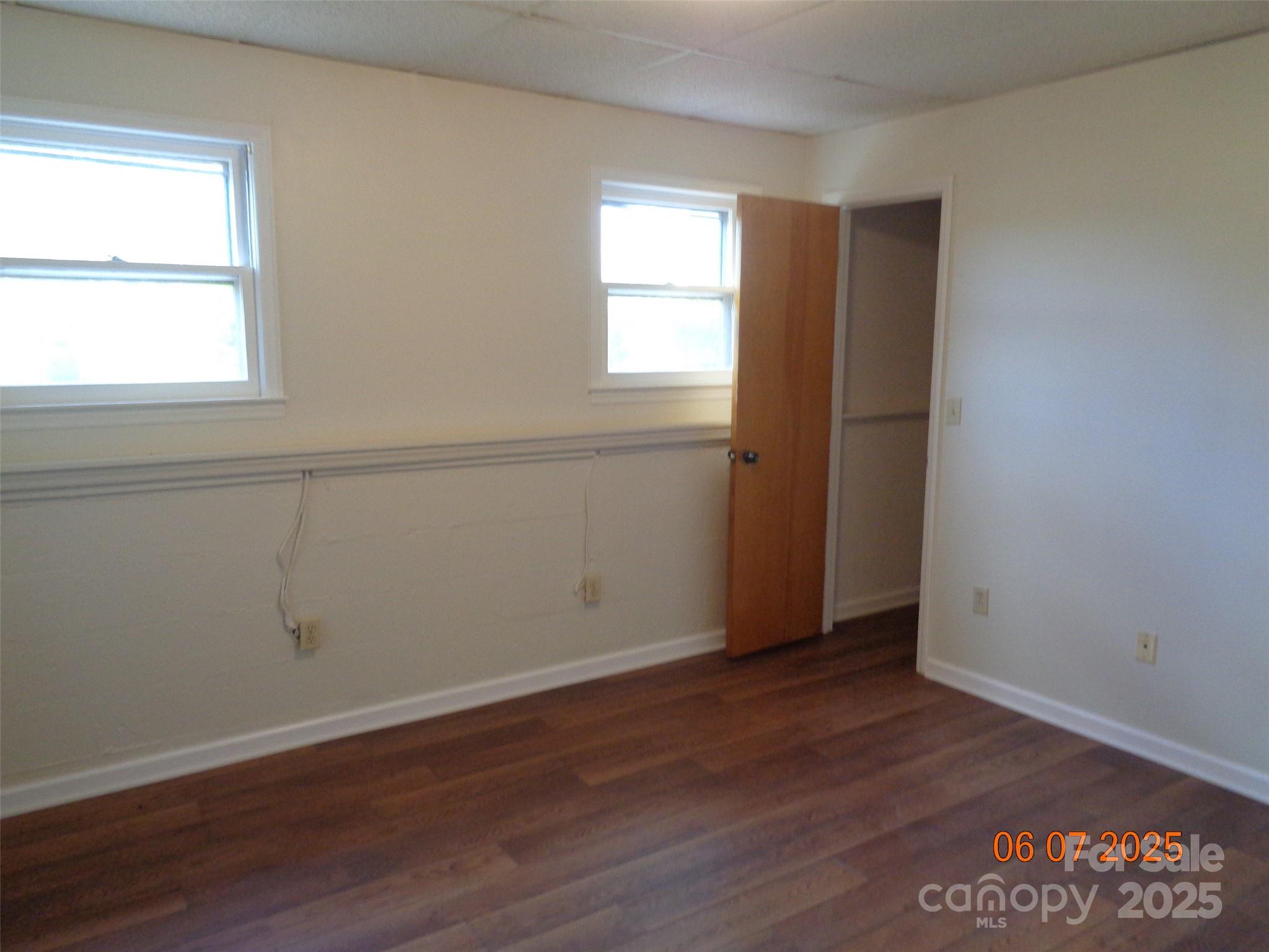 1203 Dudley Shoals Road Granite Falls, NC 28630 - Photo 31 of 32 an empty room with wooden floor and window