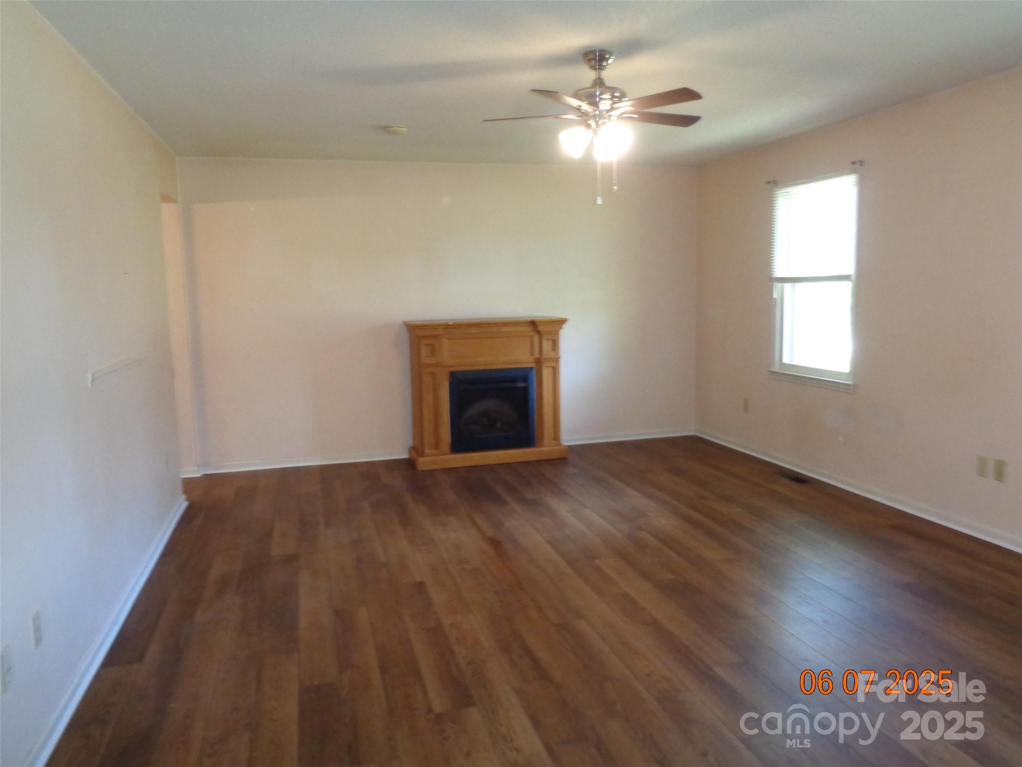 1203 Dudley Shoals Road Granite Falls, NC 28630 - Photo 8 of 32 wooden floor chandelier fan and windows in a room