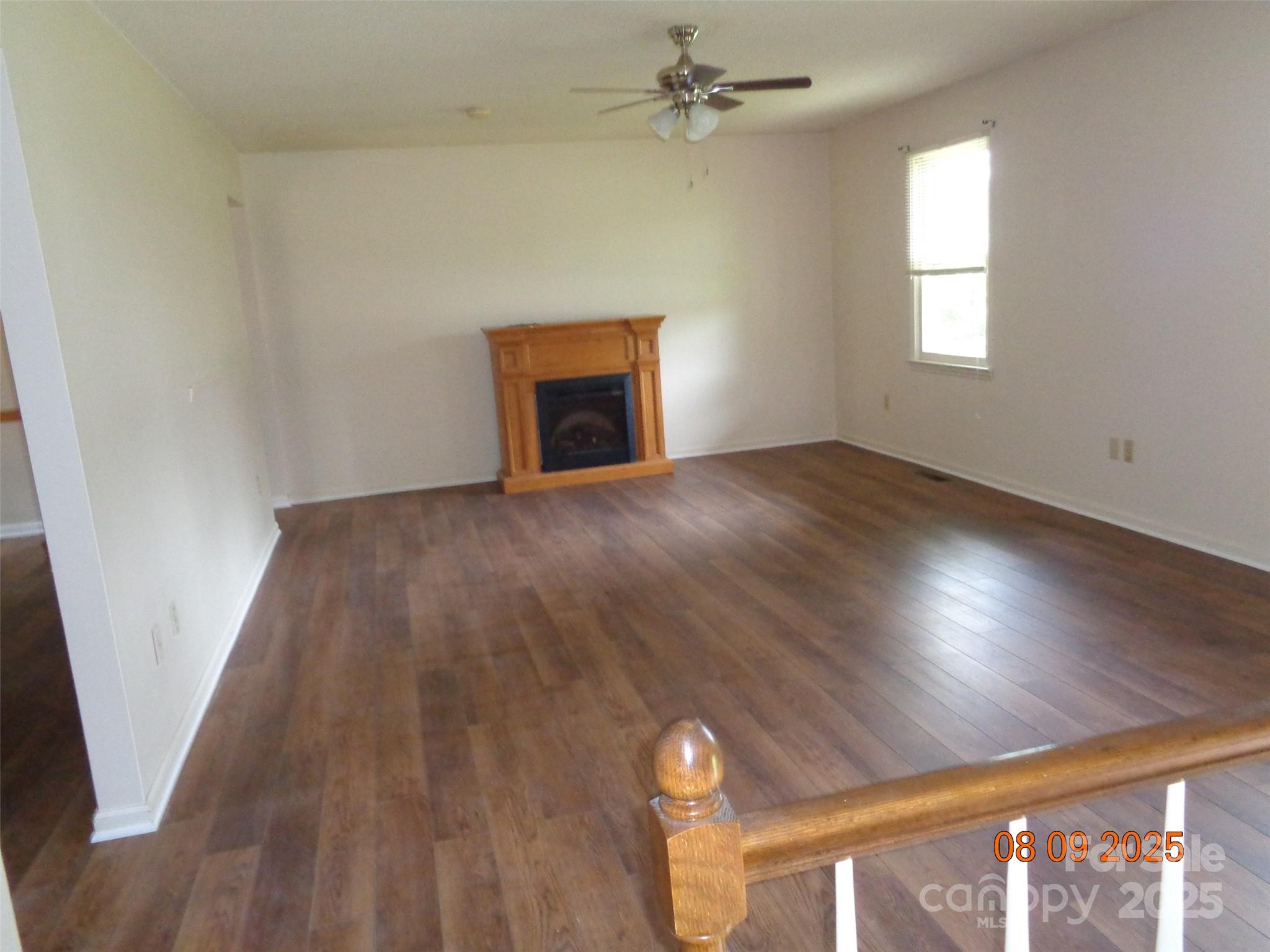 1203 Dudley Shoals Road Granite Falls, NC 28630 - Photo 10 of 32 a view of empty room with wooden floor and fan