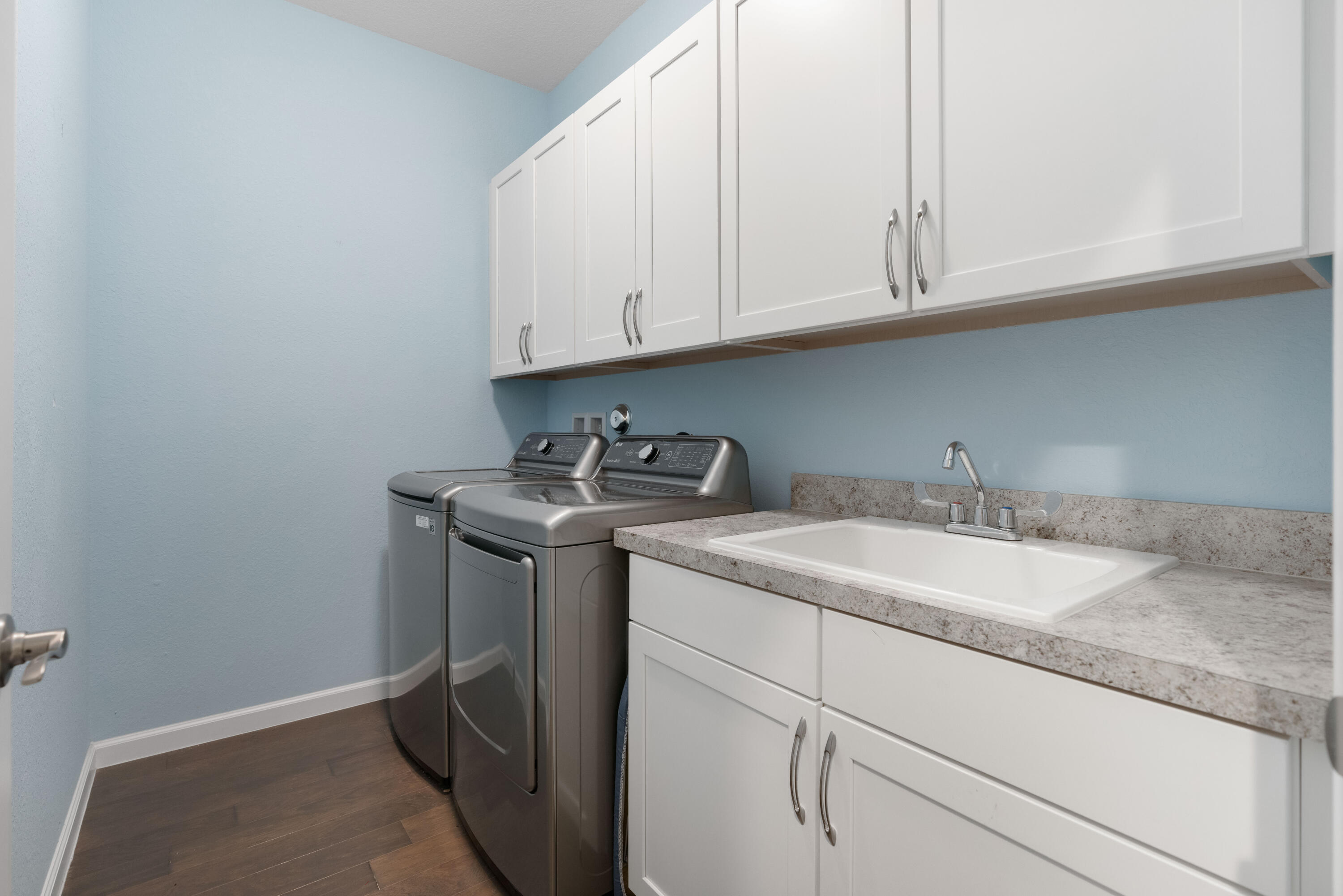 7018 Limestone Cay Road Jupiter, FL 33458 - Photo 15 of 23 a utility room with granite countertop white cabinets and a sink