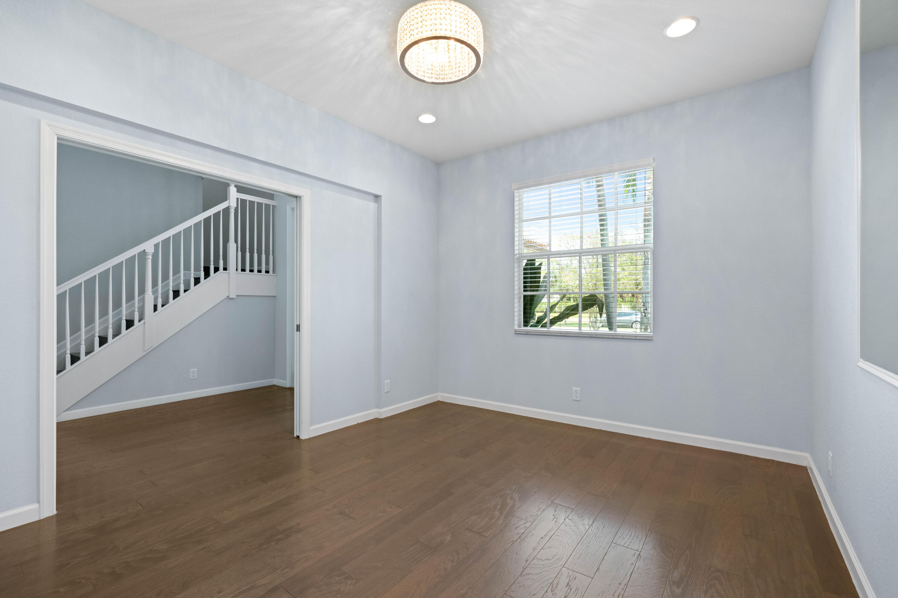 7018 Limestone Cay Road Jupiter, FL 33458 - Photo 18 of 23 an empty room with wooden floor and windows