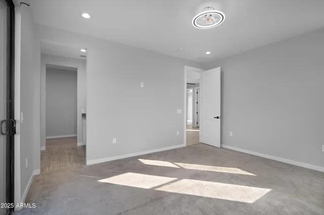 a white toilet sitting next to a bathroom sink and a mirror