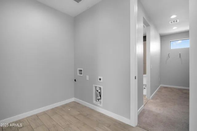 an empty room with windows and ceiling fan