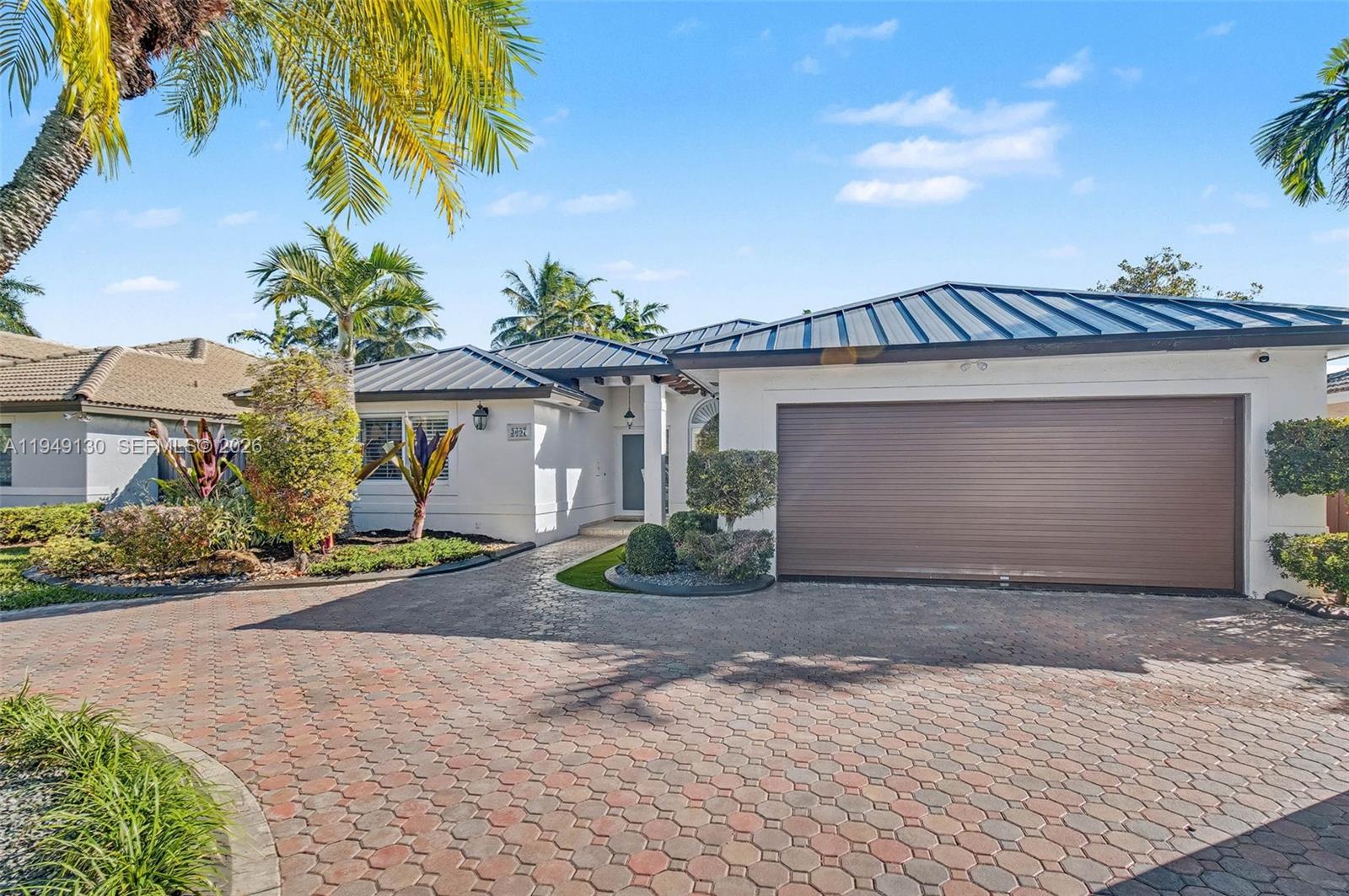 3097 Southwest 132nd Place Miami, FL 33175 - Photo 1 of 26 a front view of a house with a yard and garage