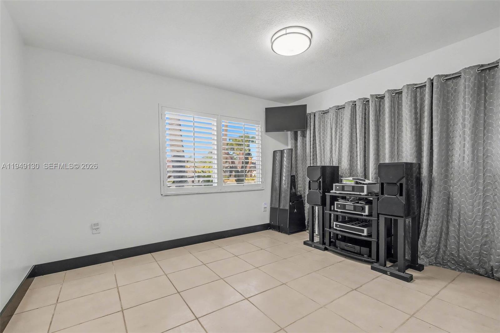 3097 Southwest 132nd Place Miami, FL 33175 - Photo 15 of 26 a view of a bedroom with furniture and window