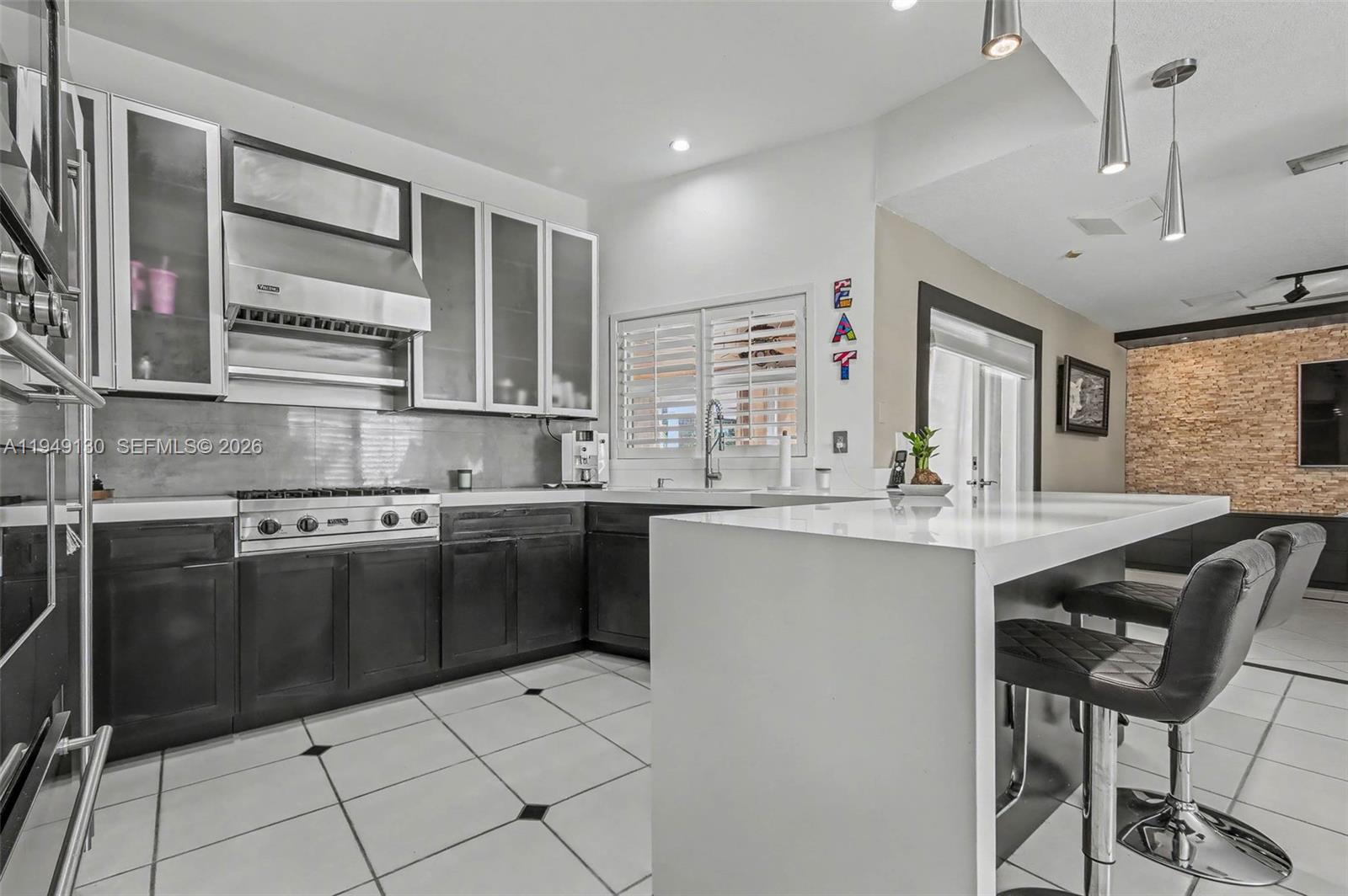 3097 Southwest 132nd Place Miami, FL 33175 - Photo 7 of 26 a kitchen with stainless steel appliances granite countertop a sink and stove