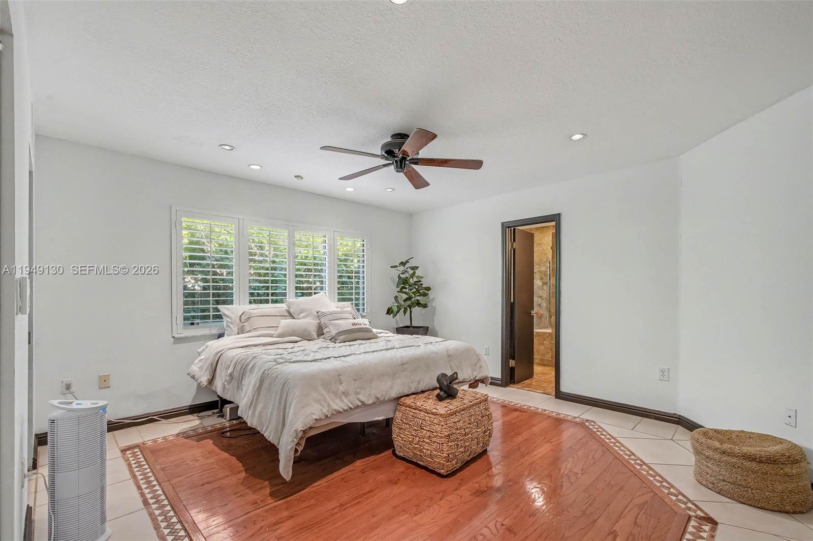 3097 Southwest 132nd Place Miami, FL 33175 - Photo 10 of 26 a bed sitting in a spacious bedroom next to a window and a chandelier