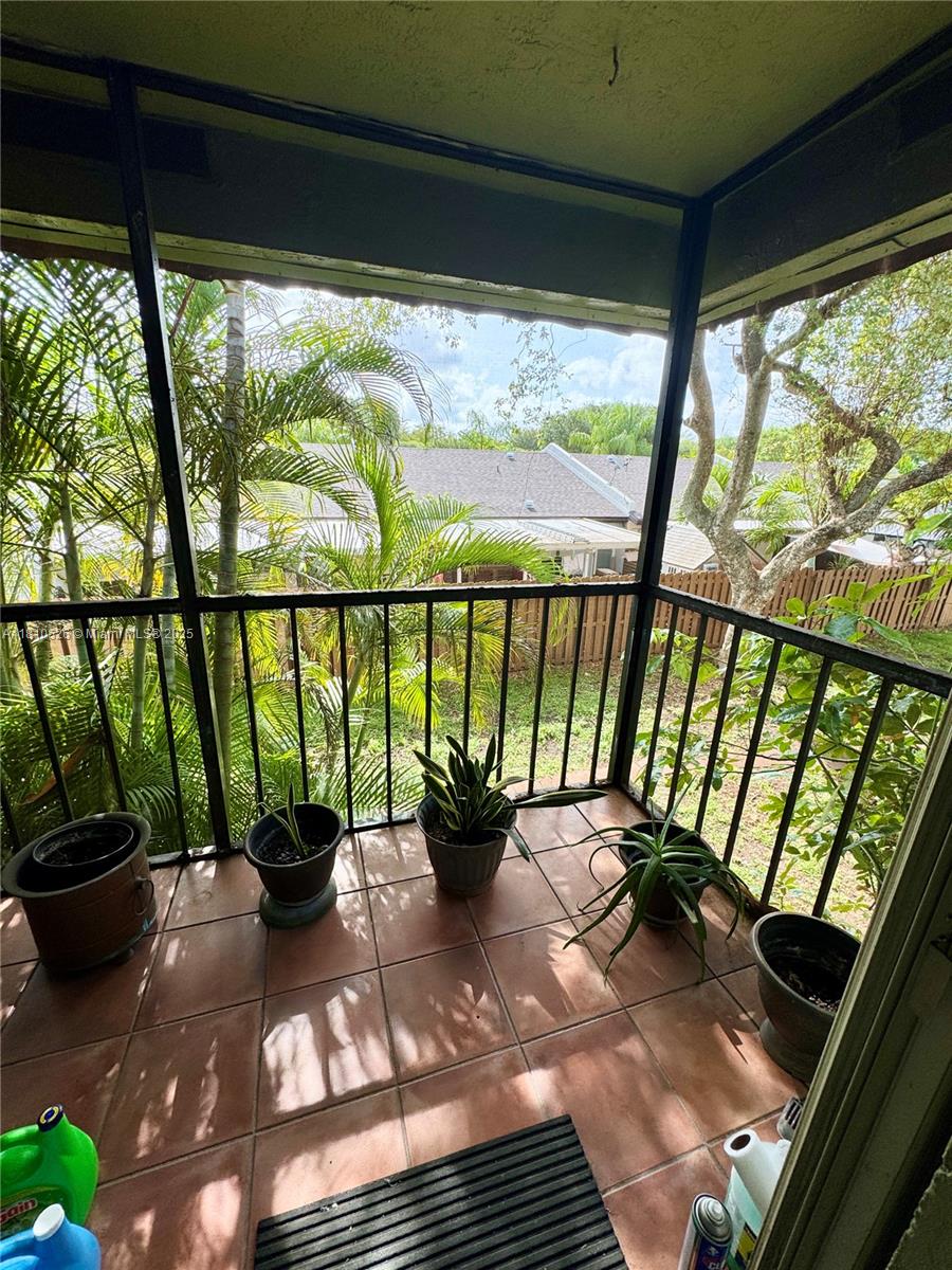 9722 Hammocks Boulevard, Unit 203 Miami, FL 33196 - Photo 14 of 16 a view of a porch with furniture