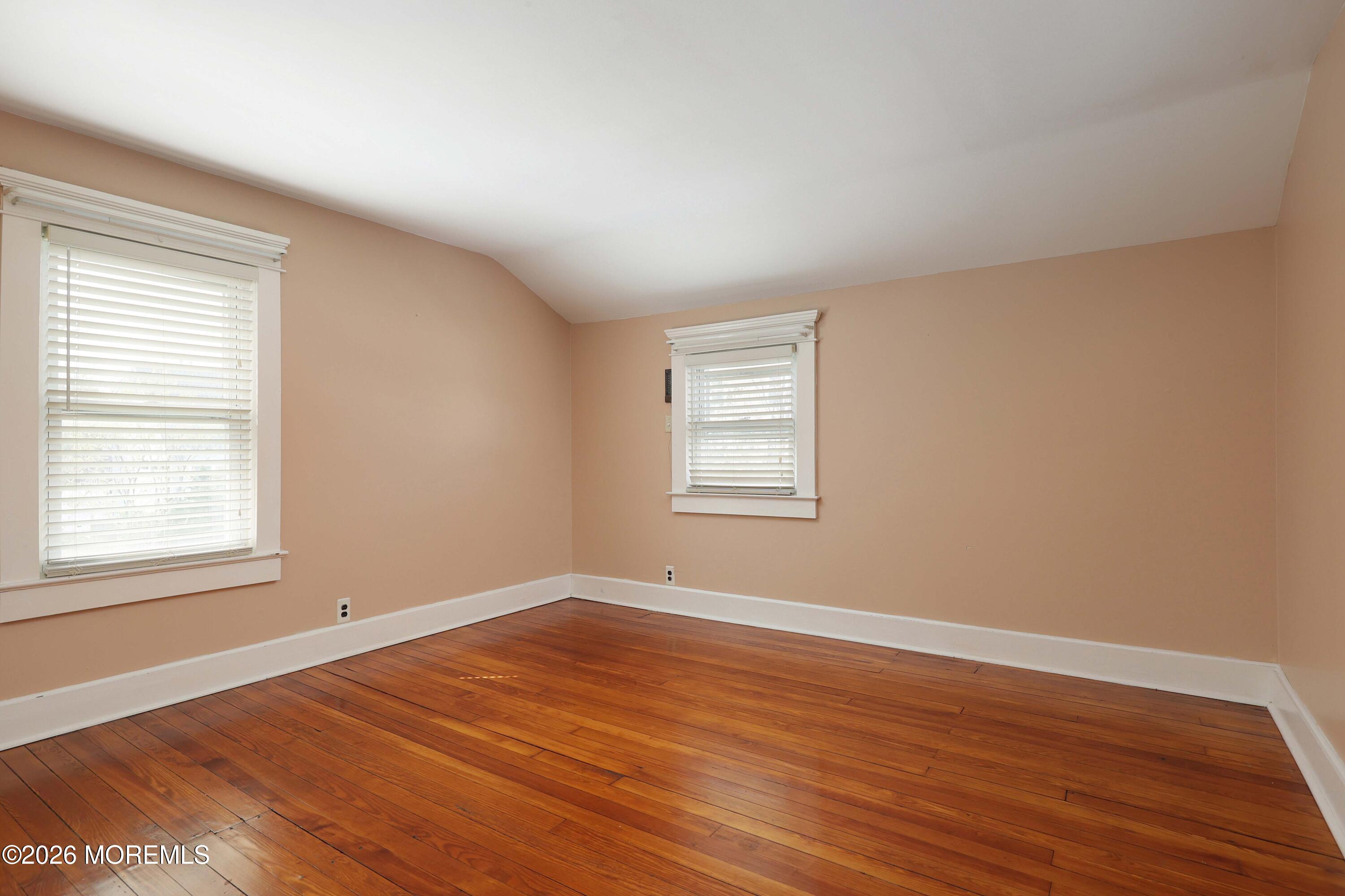 715 Howe Street Point Pleasant, NJ 08742 - Photo 17 of 45 an empty room with wooden floor and windows