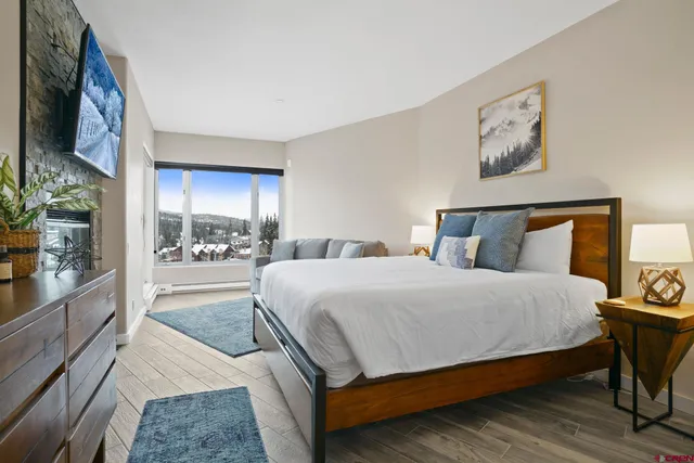 a bedroom with a large bed and a balcony