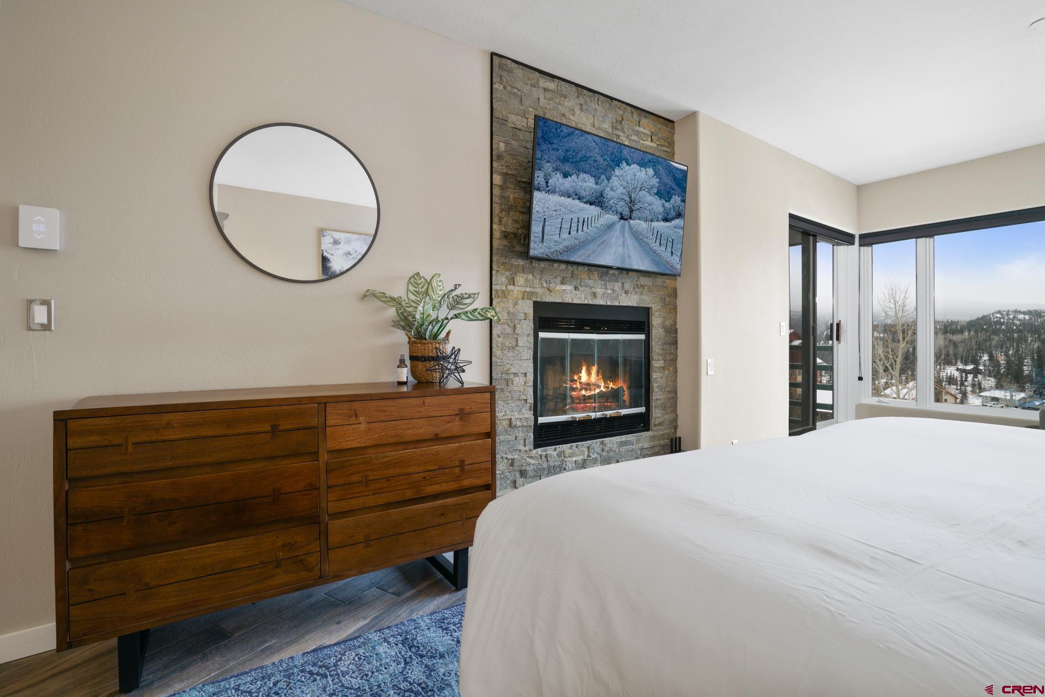 117 Needles Way, Unit 521 Durango, CO 81301 - Photo 15 of 19 a bed room with a bed and a fireplace