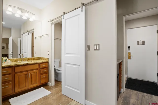 a bathroom with a double vanity sink and mirror with shower