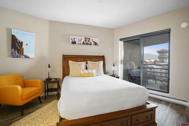 a bedroom with a bed and glass window