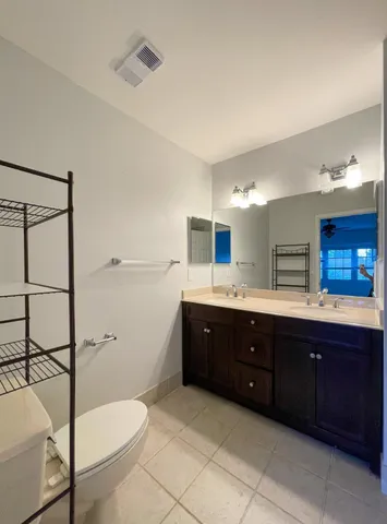 a bath room with a sink a toilet and a mirror
