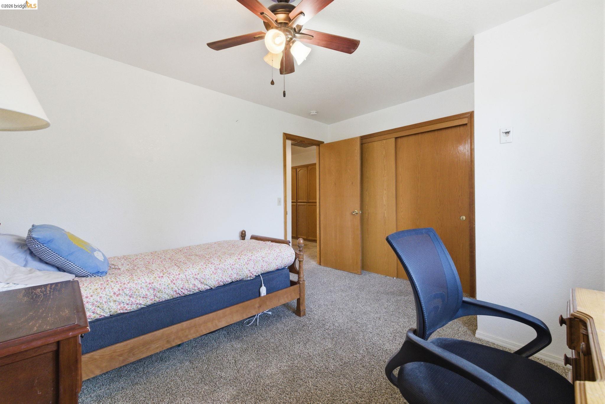 16860 Buckhorn Mountain Road Sonora, CA 95370 - Photo 16 of 46 Carpeted bedroom with a ceiling fan and a closet