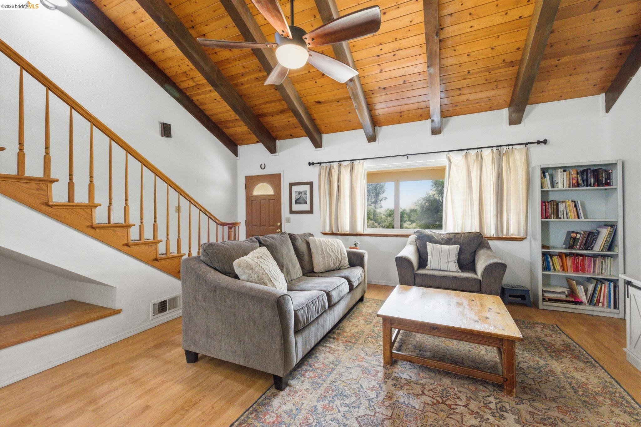 16860 Buckhorn Mountain Road Sonora, CA 95370 - Photo 26 of 46 Living room with a high wooden beamed ceiling, ceiling fan, and wood finished floors